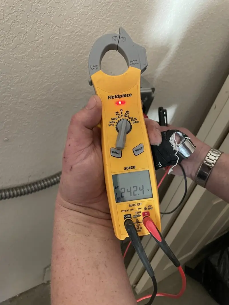 Voltage testing with clamp meter during Outlet Installation in Geneva